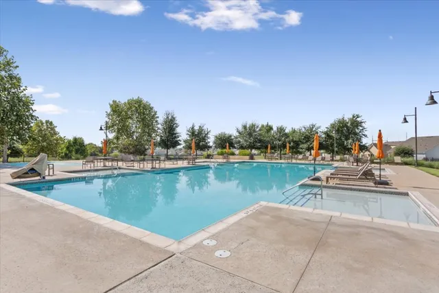 a view of a swimming pool and outdoor seating