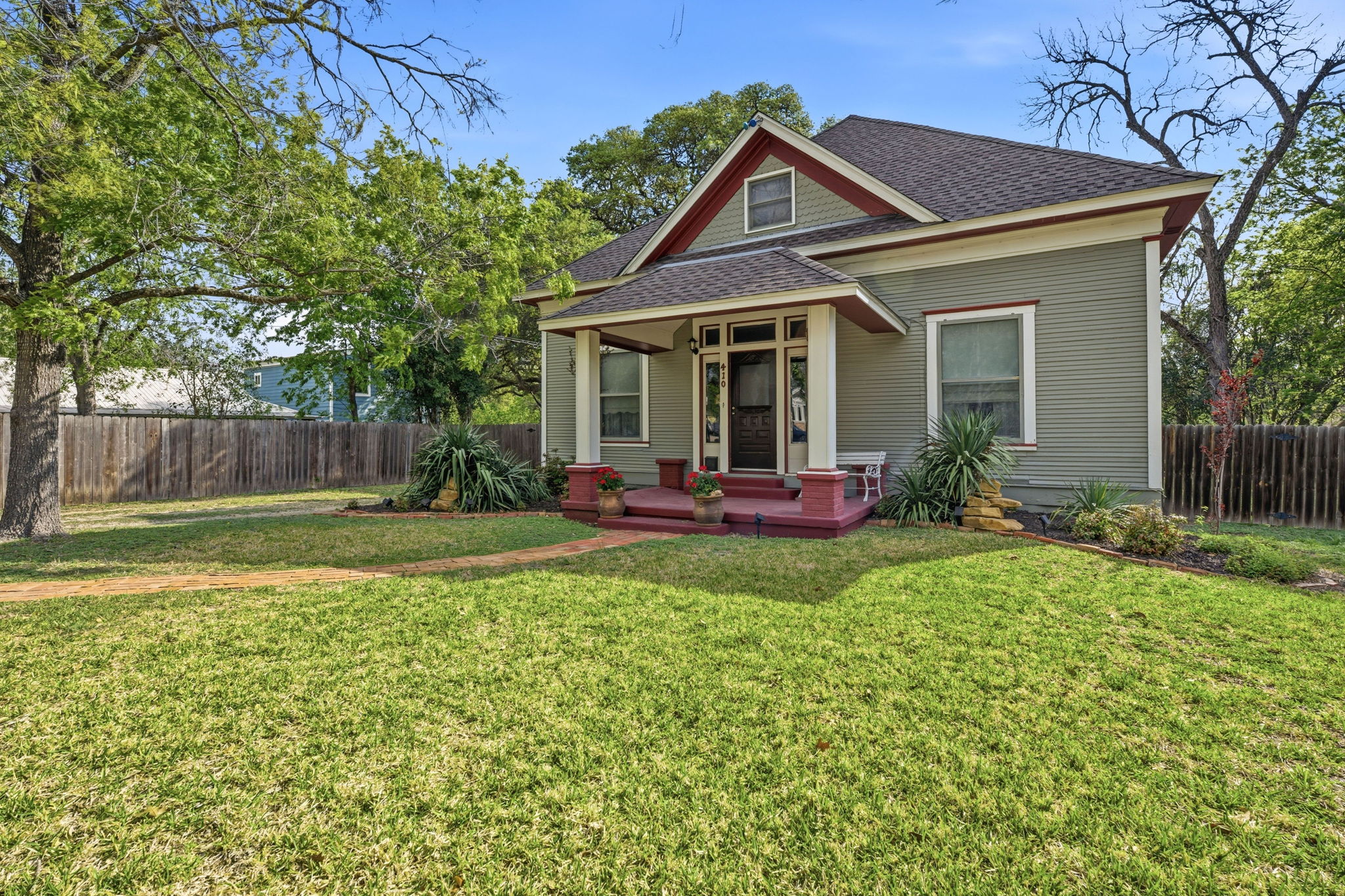 410 Cibilo Street Lockhart, TX 78644 - Photo 2 of 36 a front view of a house with garden