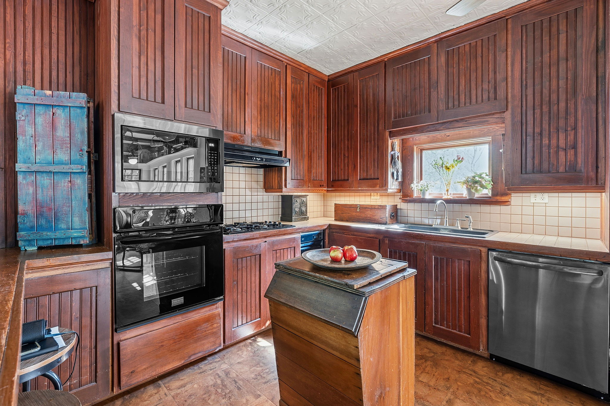 410 Cibilo Street Lockhart, TX 78644 - Photo 21 of 36 a kitchen with kitchen island granite countertop wooden cabinets appliances and a window
