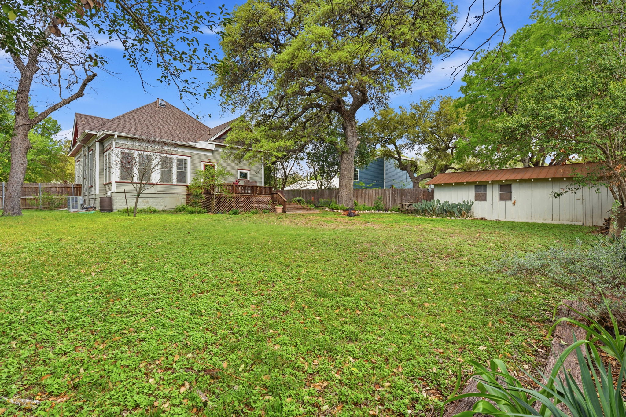 410 Cibilo Street Lockhart, TX 78644 - Photo 22 of 36 a front view of a house with a garden and trees
