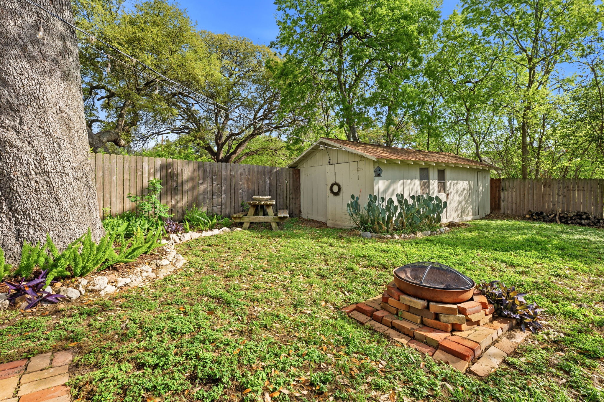 410 Cibilo Street Lockhart, TX 78644 - Photo 26 of 36 a backyard of a house with table and chairs