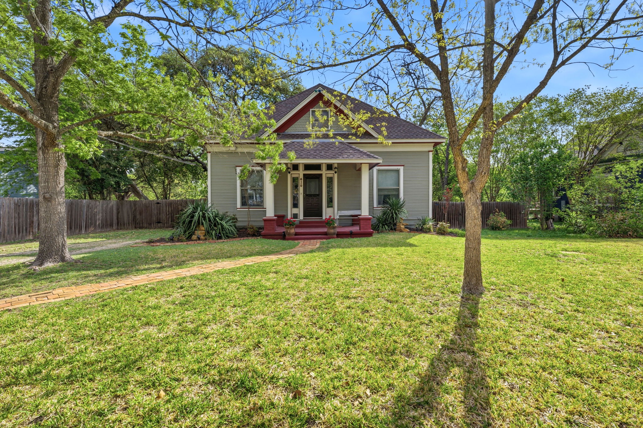 410 Cibilo Street Lockhart, TX 78644 - Photo 30 of 36 a front view of a house with garden