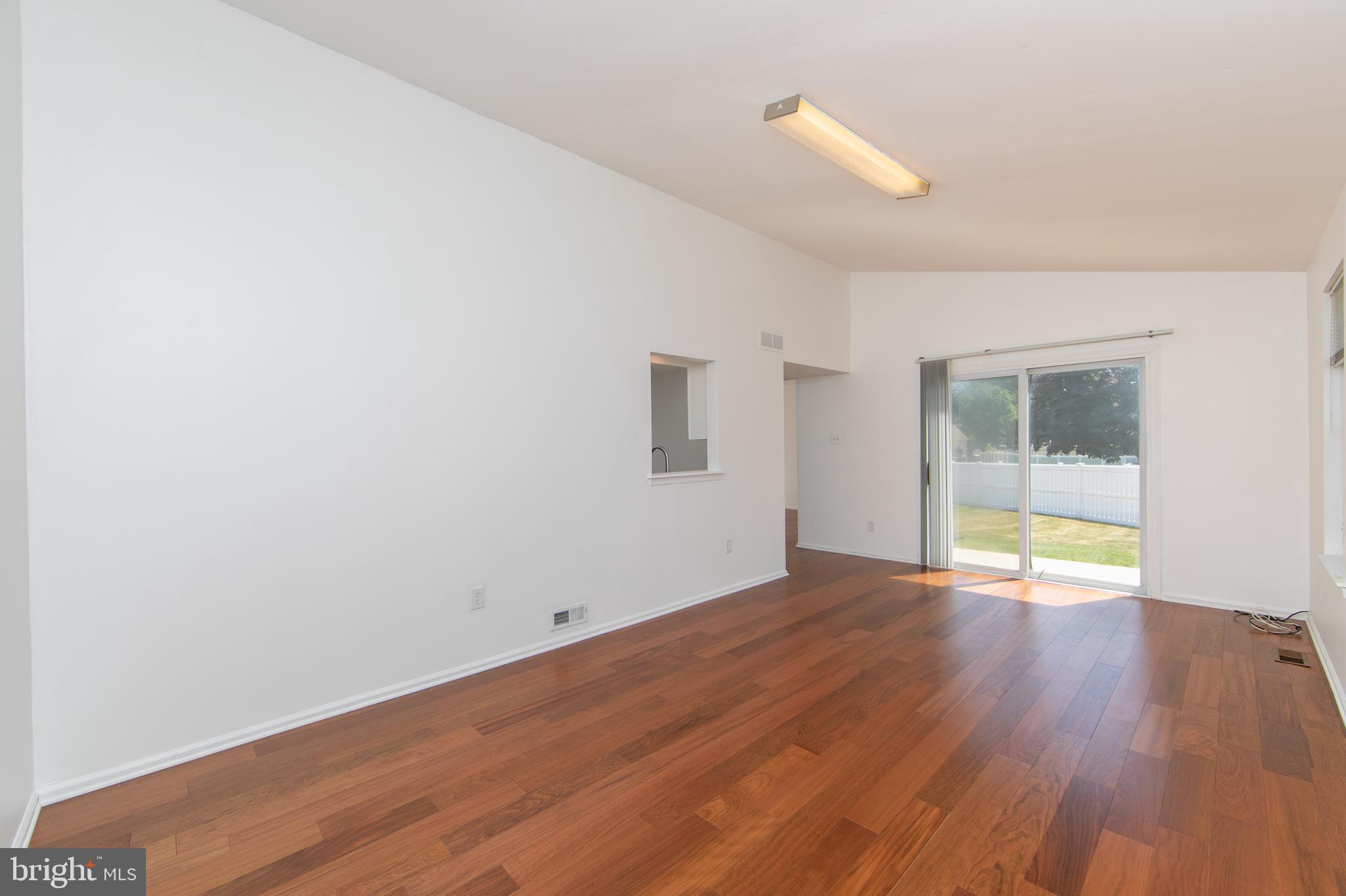 3007 Rampart Road Bensalem, PA 19020 - Photo 18 of 48 a view of an empty room with wooden floor and a window
