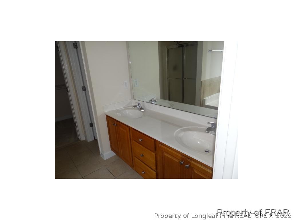 235 Hillandale Road Spring Lake, NC 28390 - Photo 12 of 25 a bathroom with sink and mirror