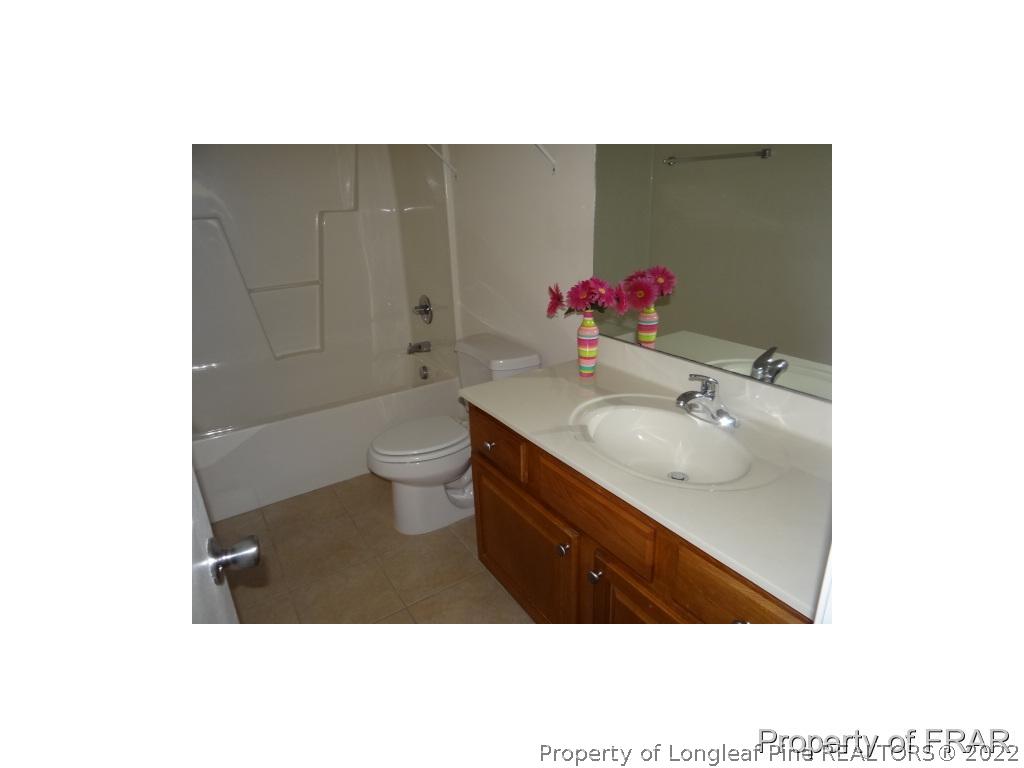 235 Hillandale Road Spring Lake, NC 28390 - Photo 17 of 25 a bathroom with a sink toilet and a mirror