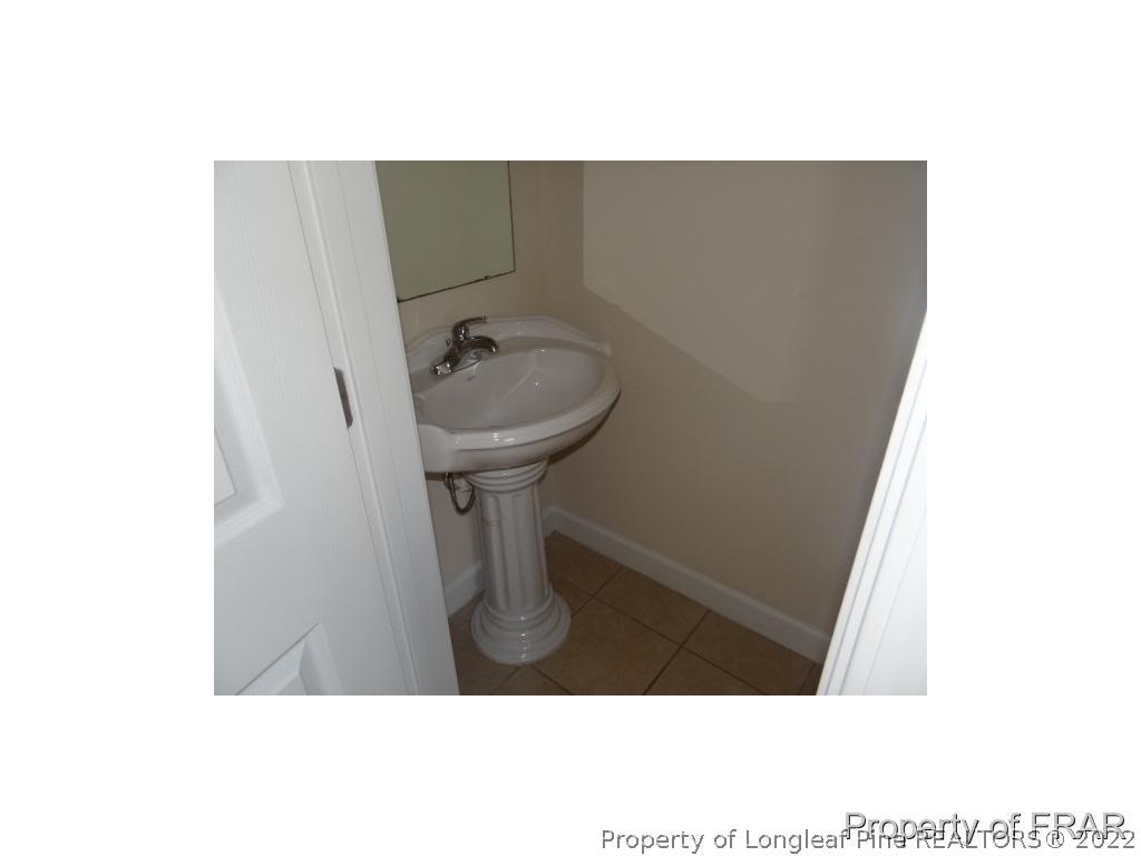 235 Hillandale Road Spring Lake, NC 28390 - Photo 10 of 25 a bathroom with a sink and a mirror