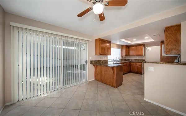 a large kitchen with a large counter top stainless steel appliances and cabinets