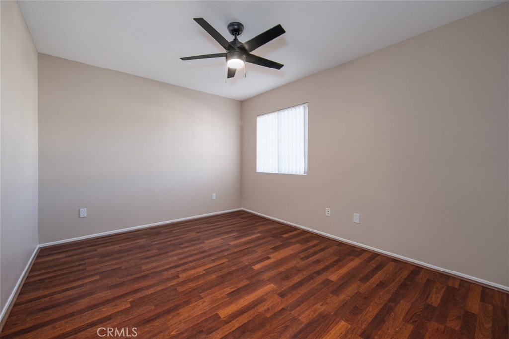 31255 Slate Street Mentone, CA 92359 - Photo 19 of 28 an empty room with wooden floor and windows