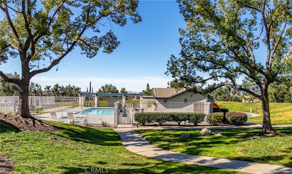 31255 Slate Street Mentone, CA 92359 - Photo 25 of 28 a view of a house with a yard and a large tree