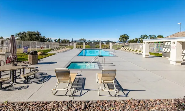 a view of a swimming pool with outdoor seating space