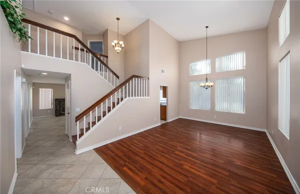 a view of staircase with white walls and wooden floor