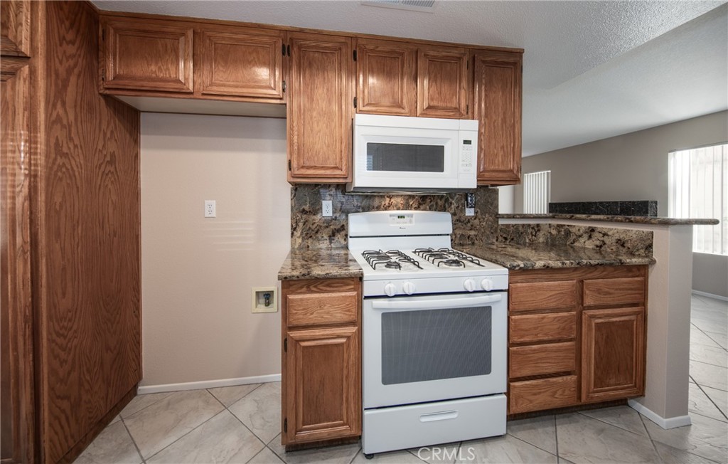 31255 Slate Street Mentone, CA 92359 - Photo 8 of 28 a kitchen with a stove and a microwave