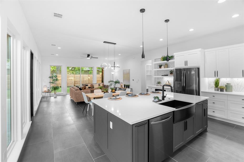 6304 Middleham Place Austin, TX 78745 - Photo 27 of 28 a kitchen with sink refrigerator and couches