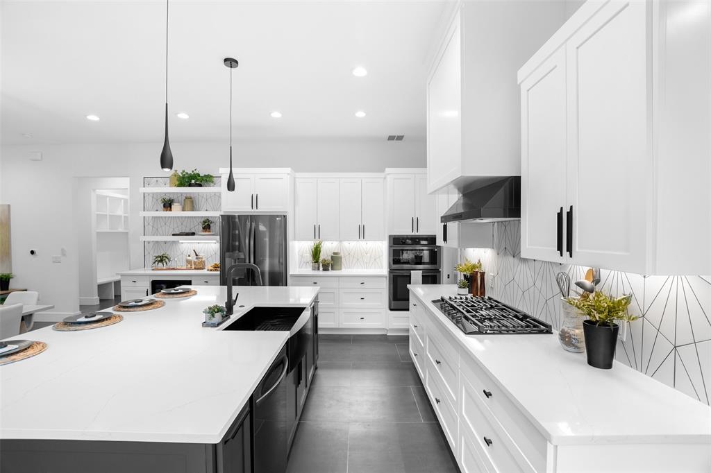 6304 Middleham Place Austin, TX 78745 - Photo 11 of 28 a kitchen with kitchen island stainless steel appliances a sink a counter top space stove and cabinets