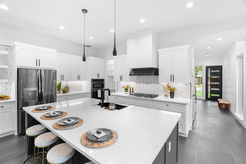 6304 Middleham Place Austin, TX 78745 - Photo 13 of 28 a kitchen with kitchen island white cabinets and refrigerator