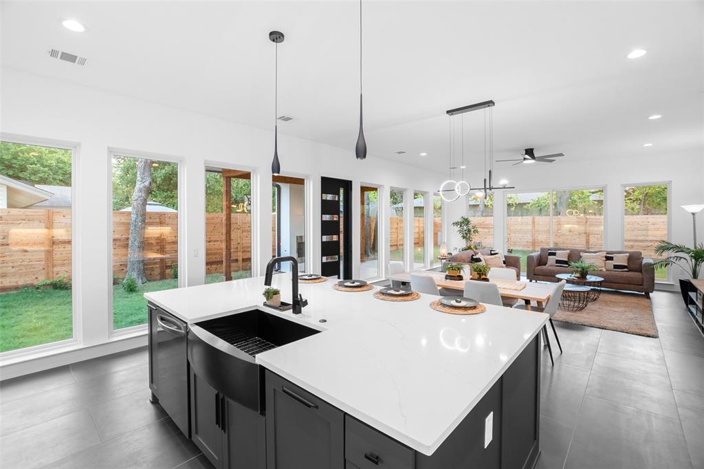 6304 Middleham Place Austin, TX 78745 - Photo 28 of 28 a kitchen with sink a stove and chairs