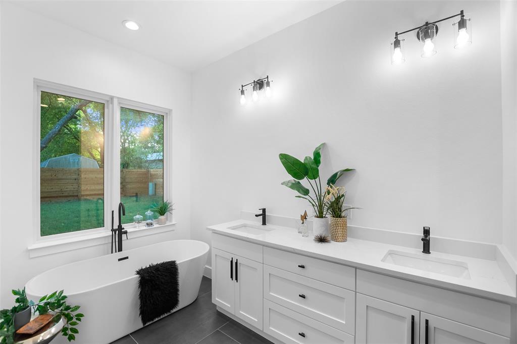 6304 Middleham Place Austin, TX 78745 - Photo 19 of 28 a bathroom with a sink a mirror and a potted plant