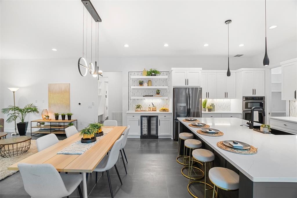 6304 Middleham Place Austin, TX 78745 - Photo 5 of 28 a kitchen with stainless steel appliances a table chairs and a refrigerator