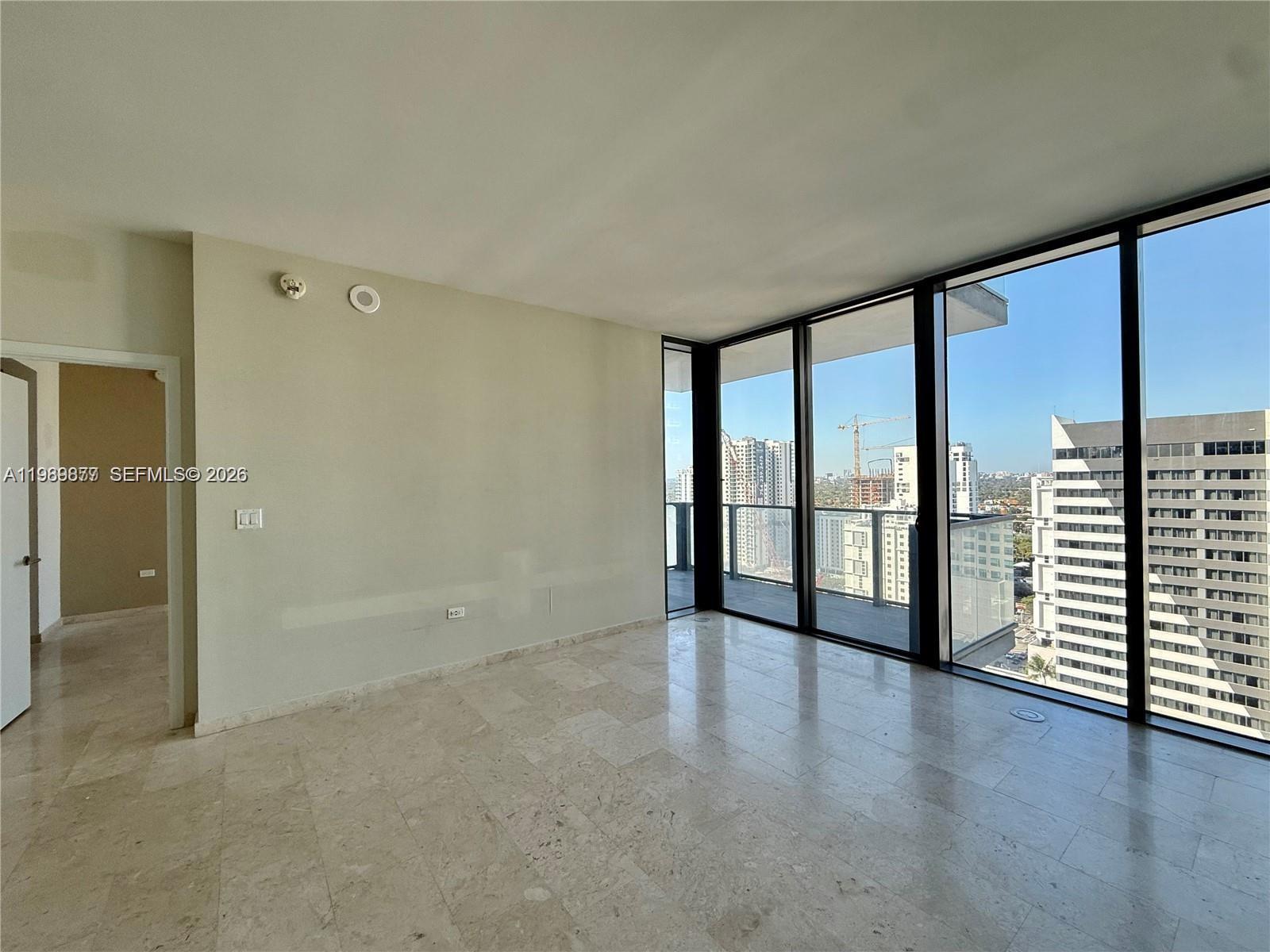 88 Southwest 7th Street, Unit 1808 Miami, FL 33130 - Photo 2 of 9 wooden floor in an empty room with a window