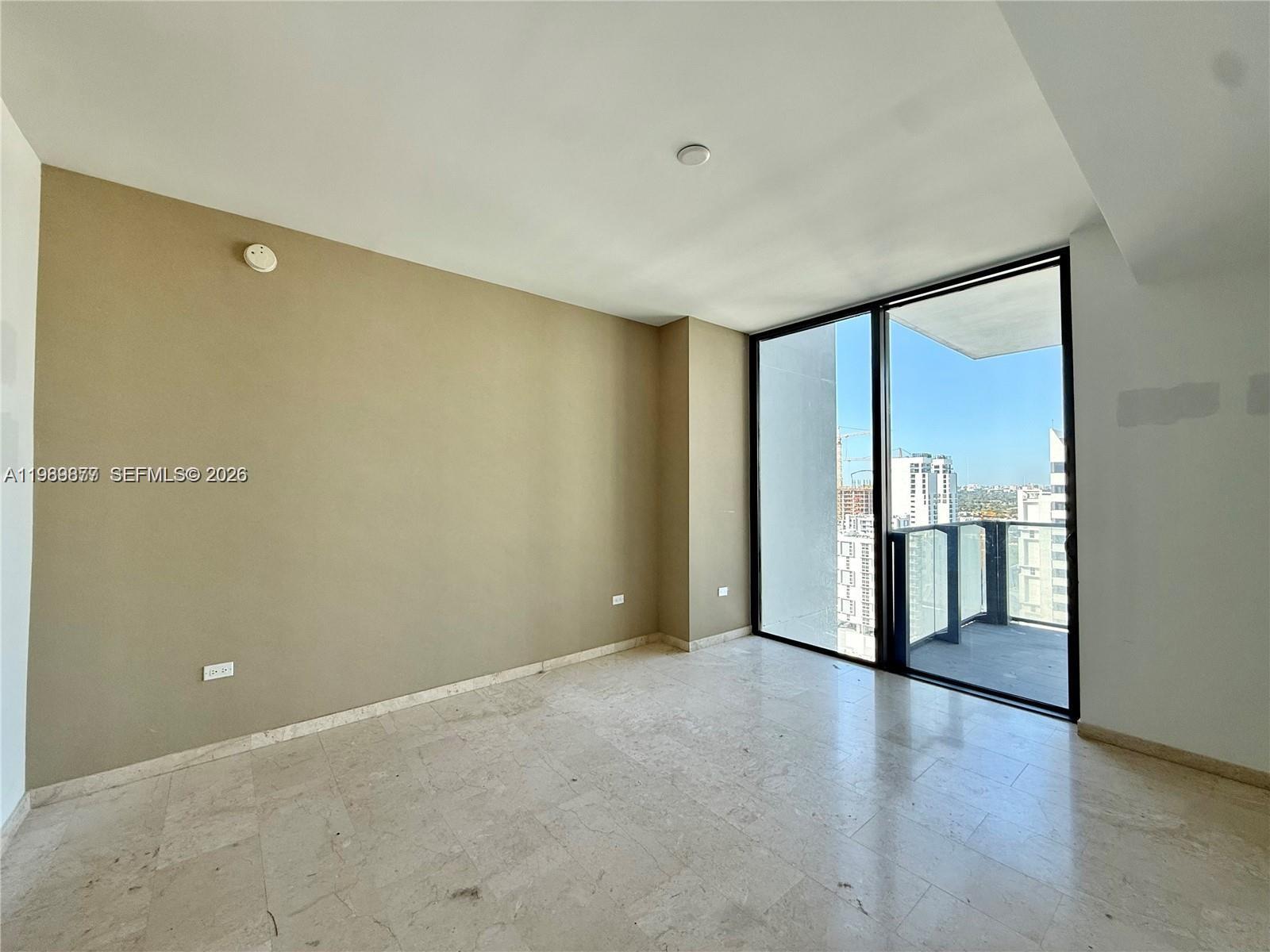 88 Southwest 7th Street, Unit 1808 Miami, FL 33130 - Photo 4 of 9 a view of an empty room with a window