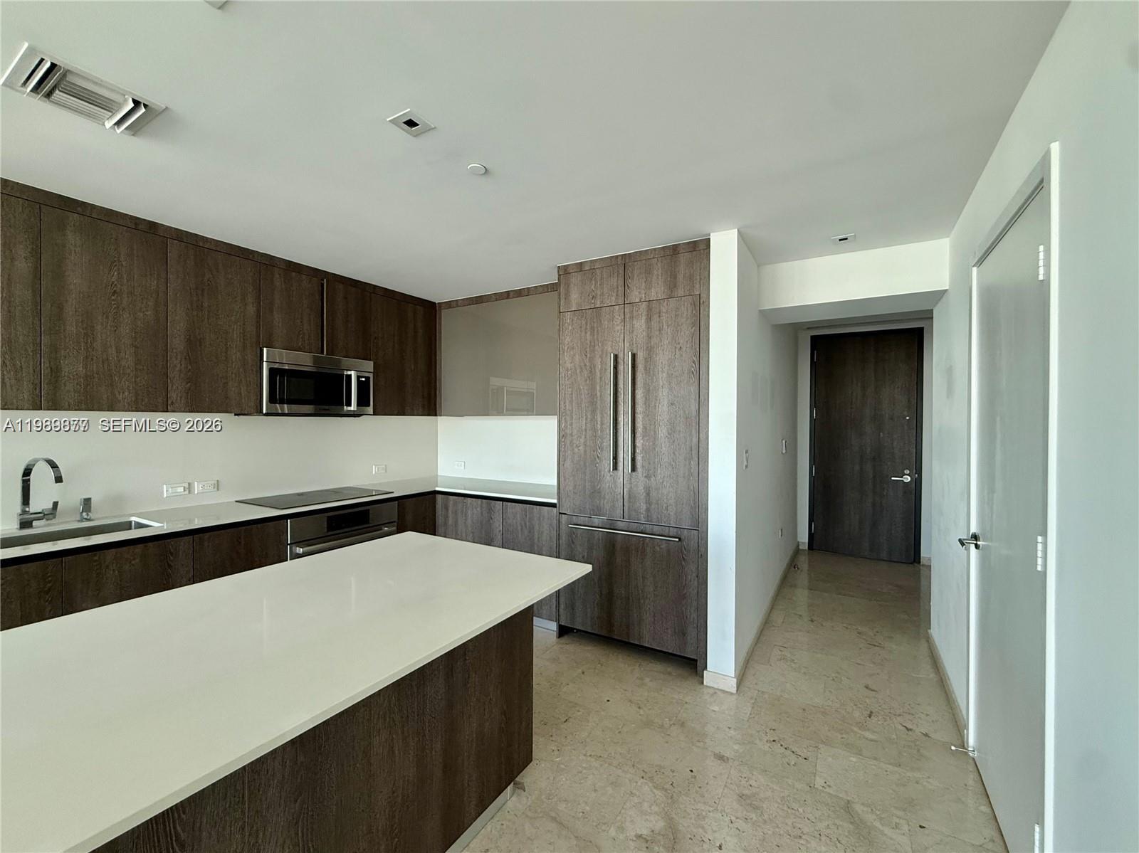 88 Southwest 7th Street, Unit 1808 Miami, FL 33130 - Photo 5 of 9 a kitchen with stainless steel appliances a refrigerator and a stove