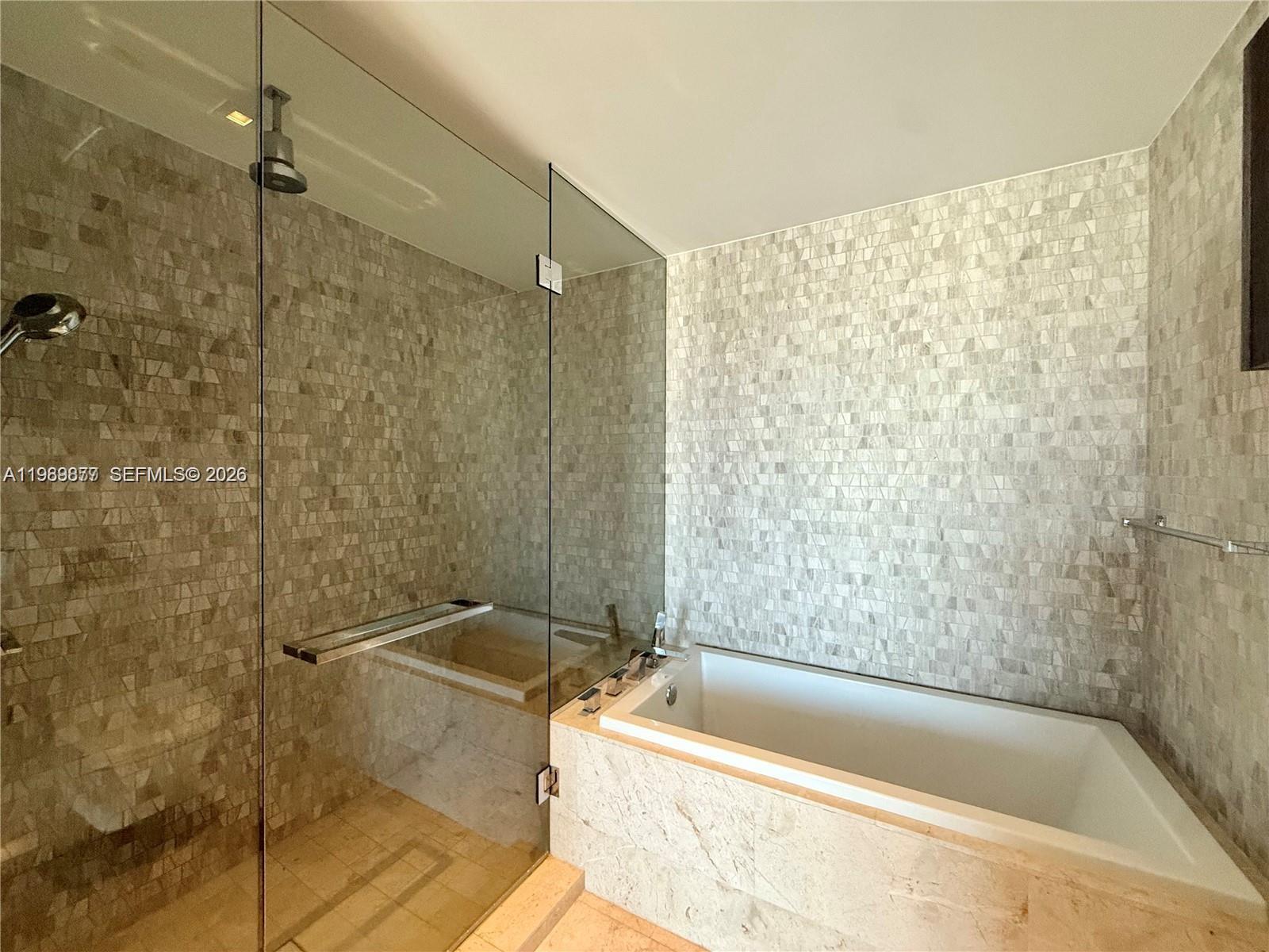 88 Southwest 7th Street, Unit 1808 Miami, FL 33130 - Photo 6 of 9 a bathroom with a bathtub and shower