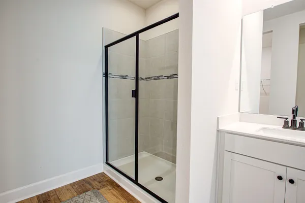 a bathroom with a shower and a sink