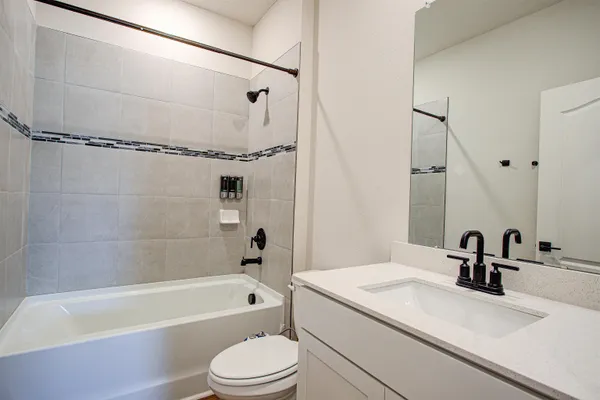 a bathroom with a sink a toilet and a bathtub