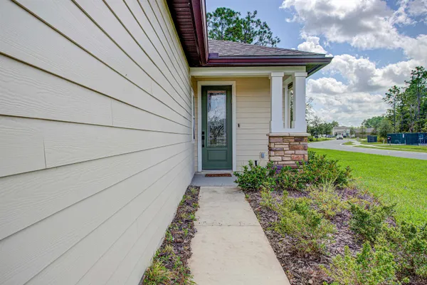 a pathway of a house with backyard