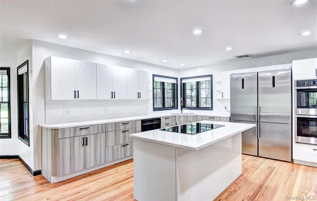 a kitchen with counter top space and wooden floor