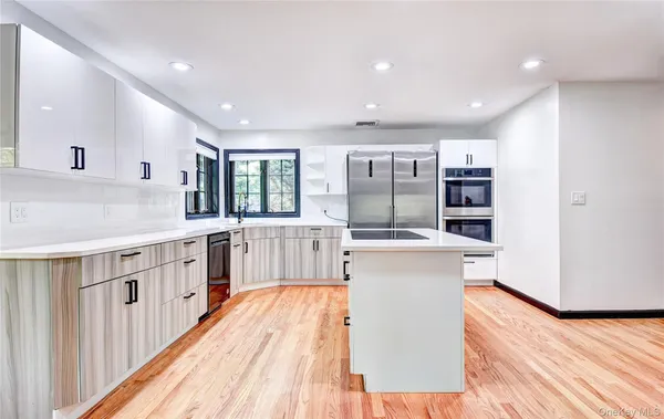 a view of a living room kitchen and a wooden floor