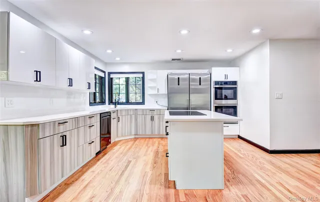 a view of a living room kitchen and a wooden floor