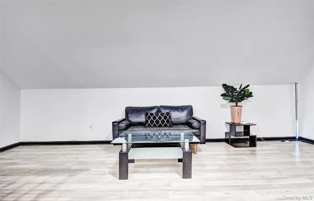 a front view of house with yard and trees around