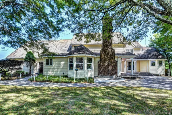 a view of a house with a yard and a forest