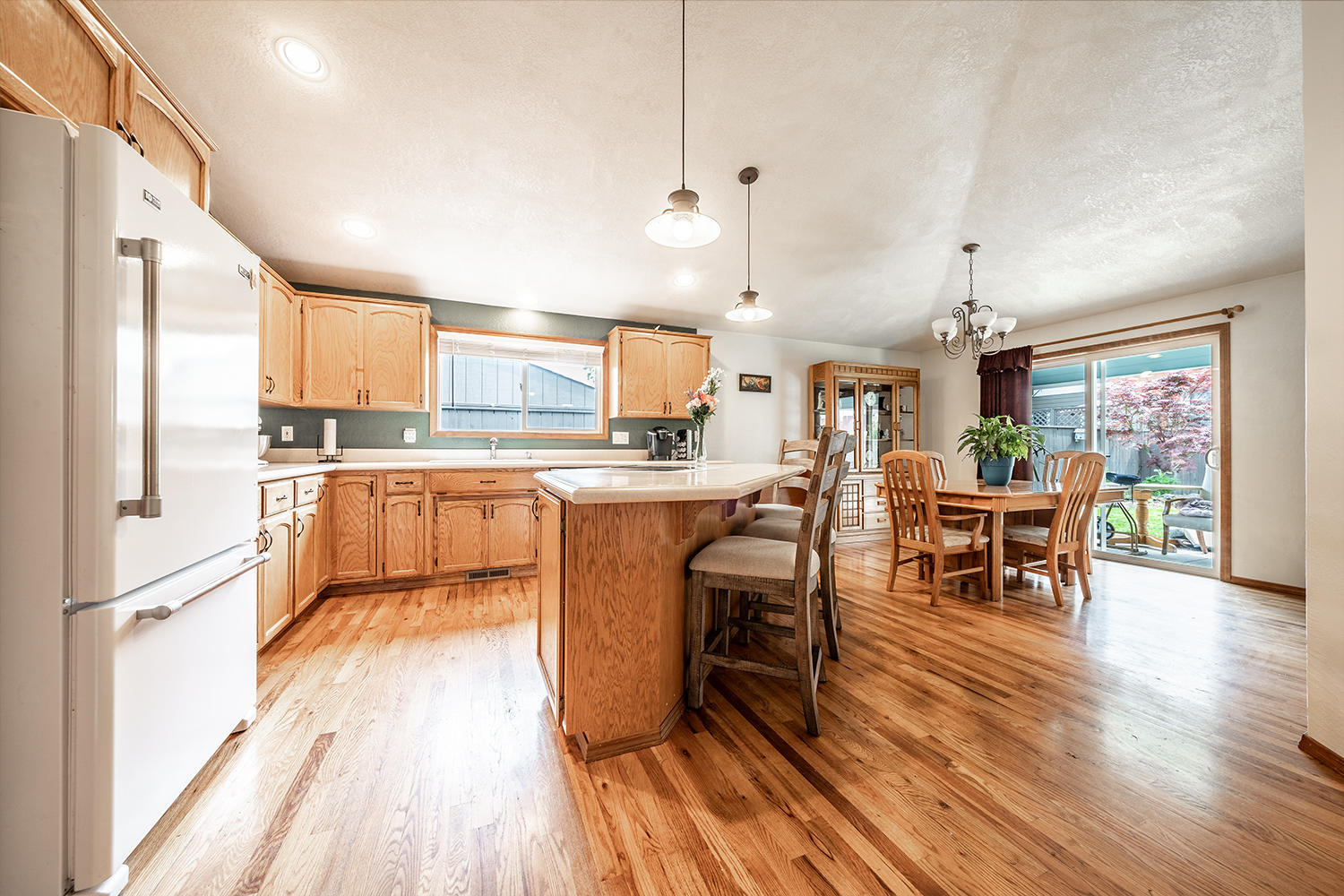 2628 Beebe Road Central Point, OR 97502 - Photo 6 of 27 a kitchen with a table chairs refrigerator and cabinets