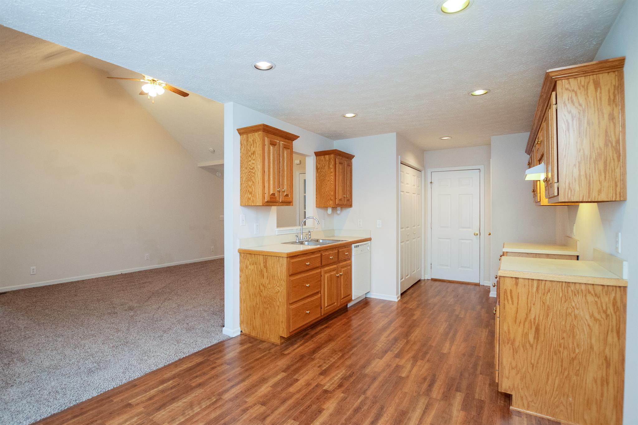 112 Fieldstone Lane Springfield, TN 37172 - Photo 13 of 24 a kitchen with wooden floors and white appliances