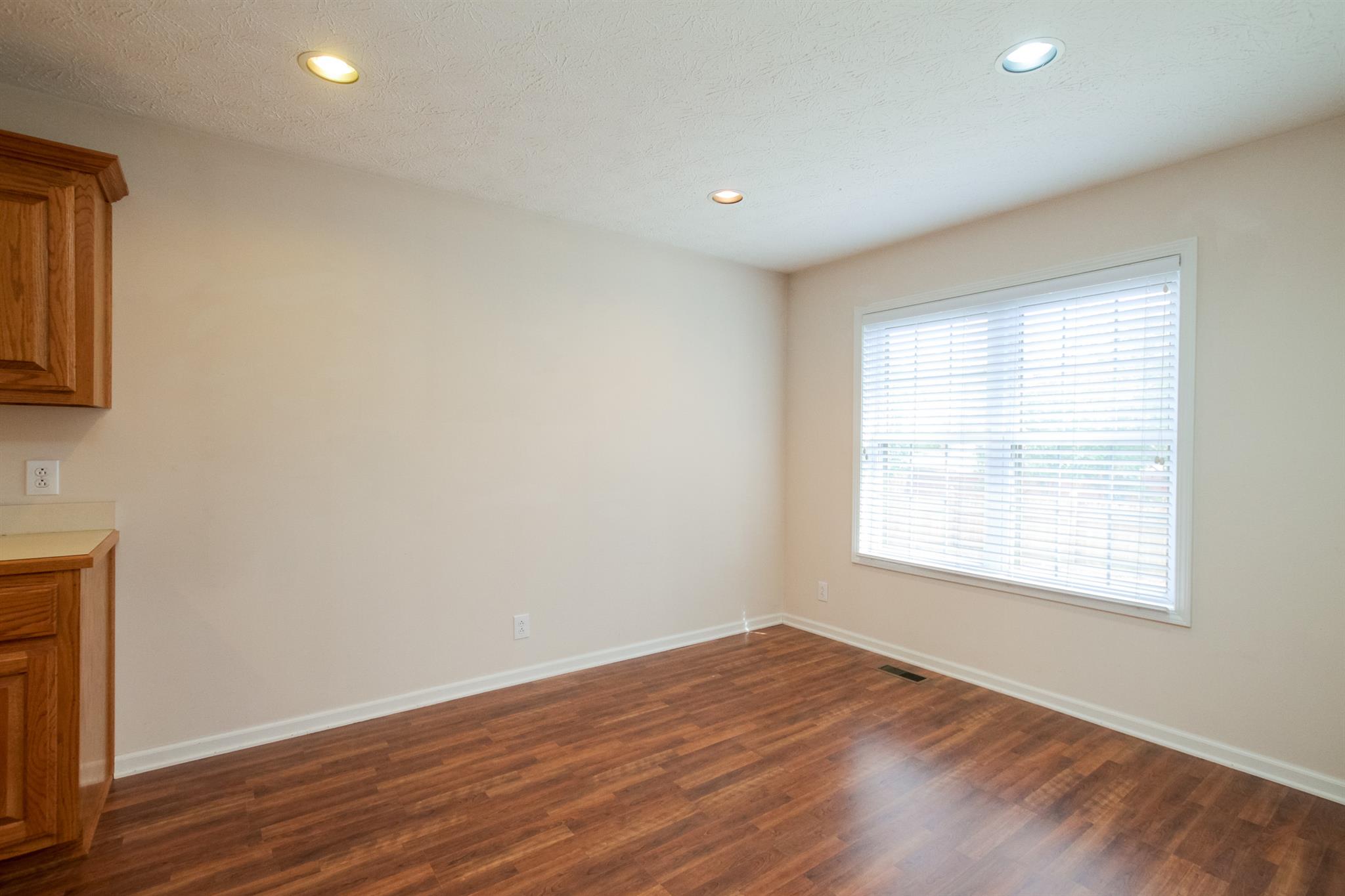112 Fieldstone Lane Springfield, TN 37172 - Photo 14 of 24 an empty room with wooden floor and windows