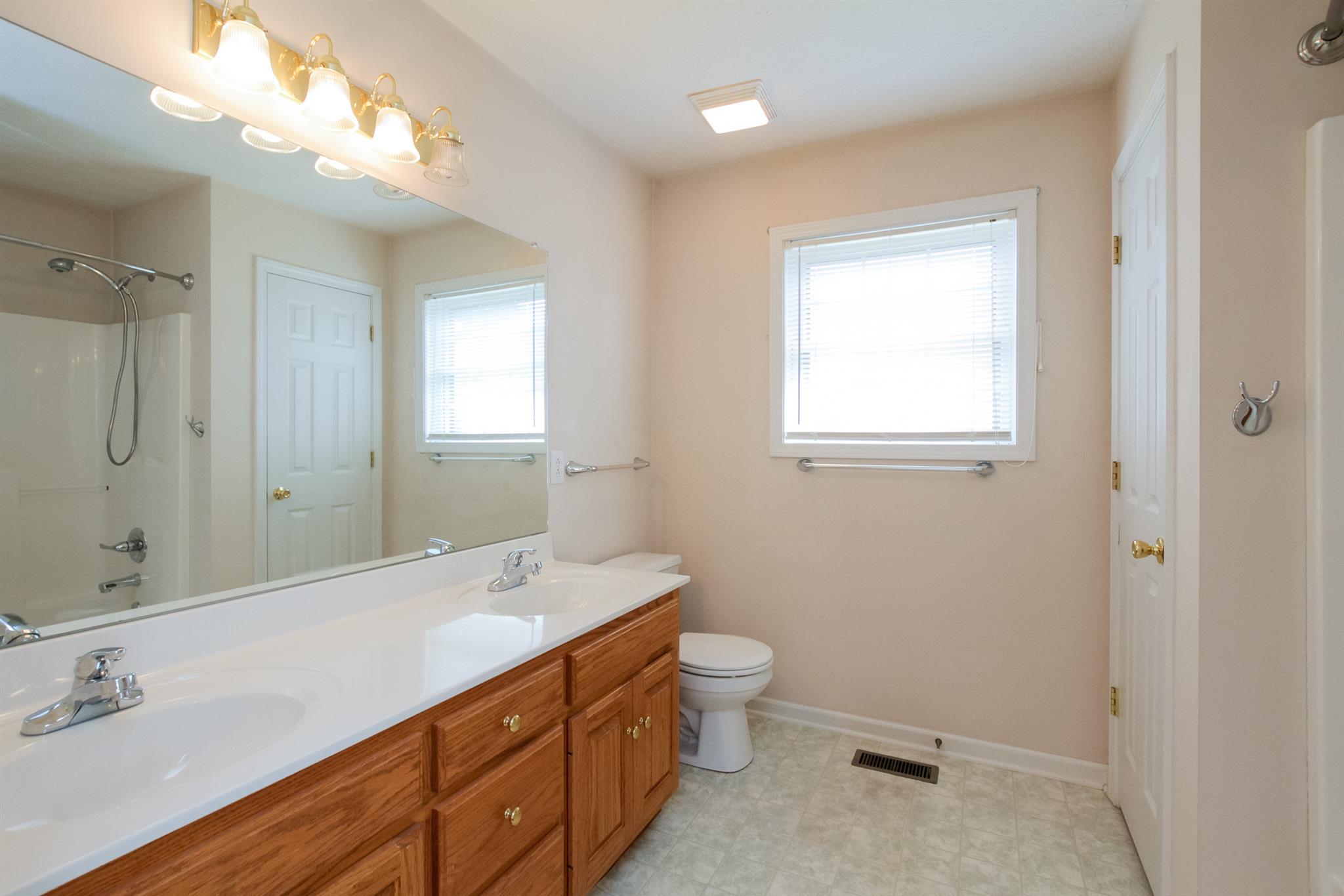 112 Fieldstone Lane Springfield, TN 37172 - Photo 17 of 24 a bathroom with a double vanity sink toilet and a mirror
