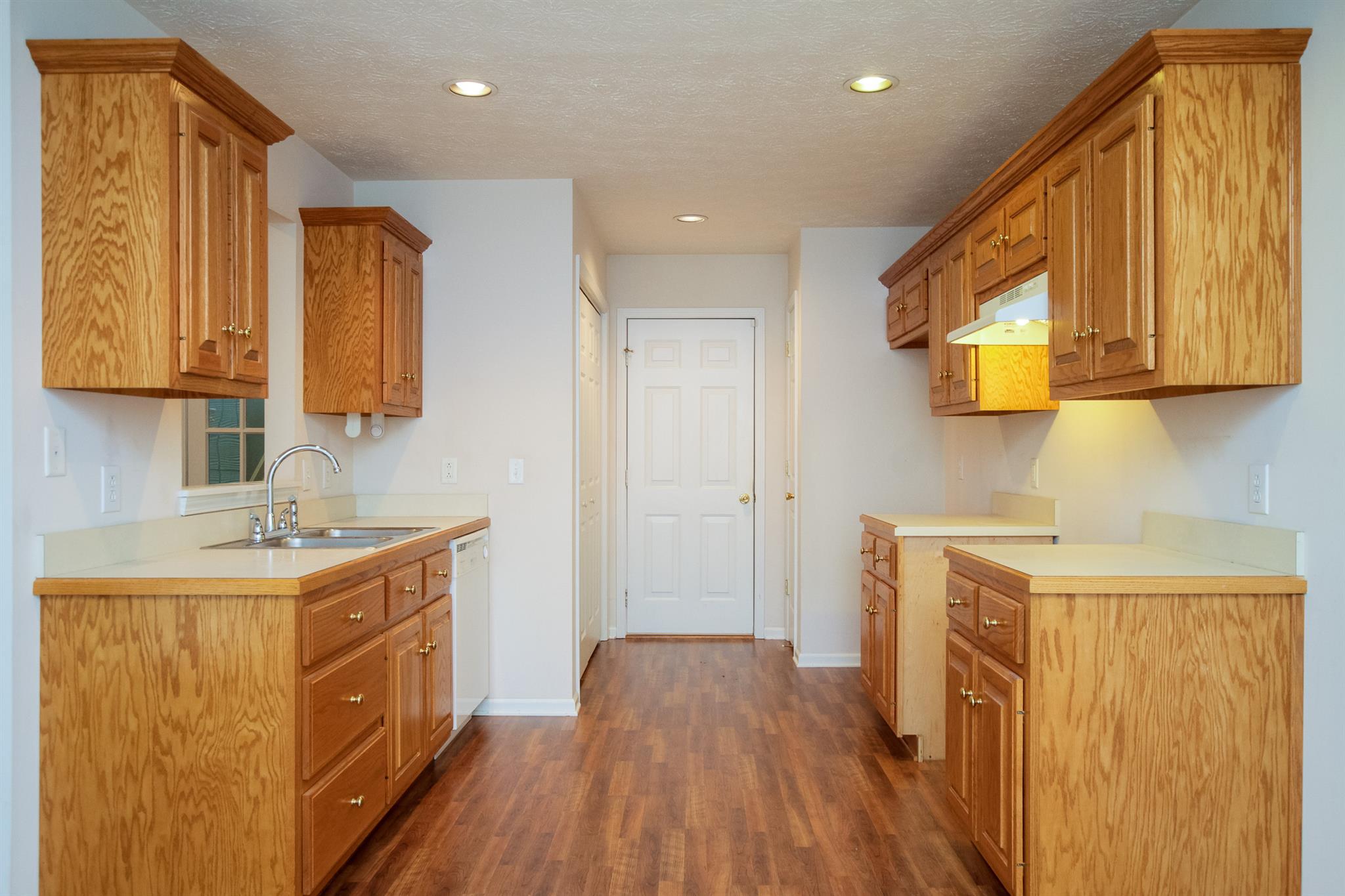 112 Fieldstone Lane Springfield, TN 37172 - Photo 10 of 24 a kitchen with a sink a refrigerator and wooden cabinets