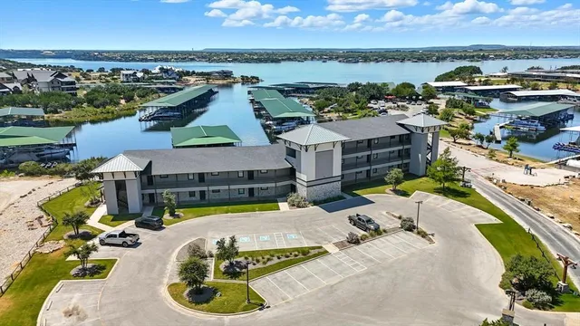 an aerial view of a house with swimming pool and ocean view