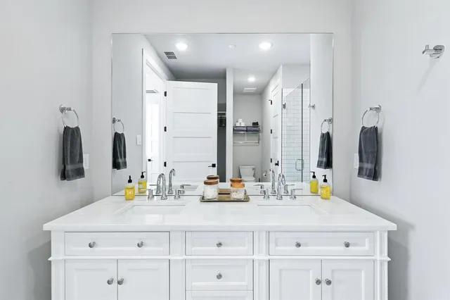 a bedroom with two beds and a flat screen tv