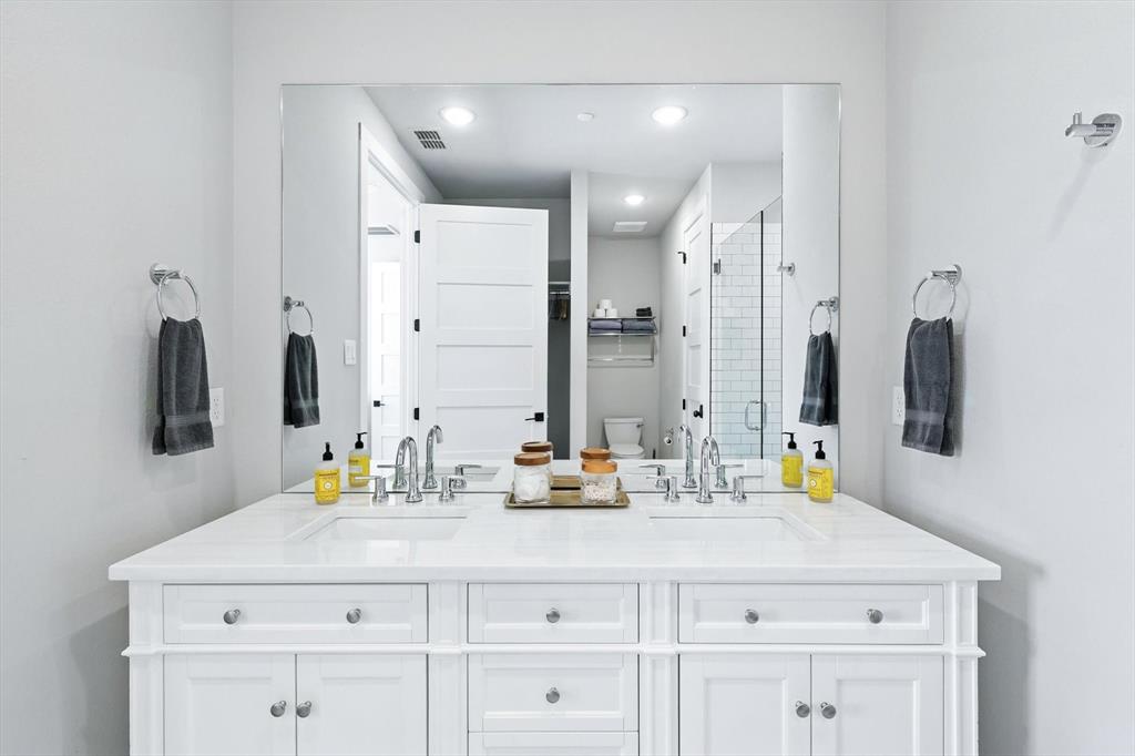 3412 Scenic Point Road, Unit 104 Graford, TX 76449 - Photo 18 of 35 a bathroom with a sink double vanity and a mirror