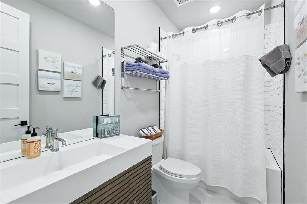3412 Scenic Point Road, Unit 104 Graford, TX 76449 - Photo 21 of 35 a bathroom with a sink toilet and shower
