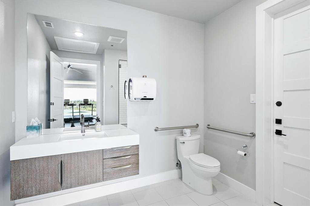 3412 Scenic Point Road, Unit 104 Graford, TX 76449 - Photo 27 of 35 a bathroom with a sink a toilet and shower
