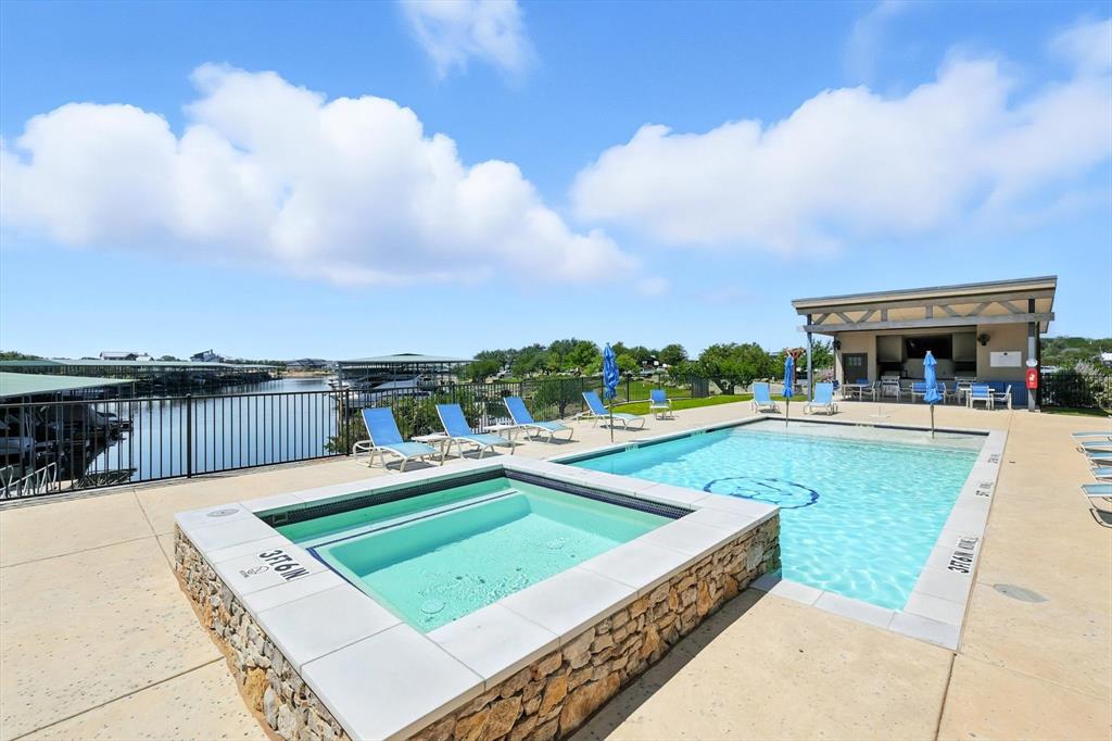3412 Scenic Point Road, Unit 104 Graford, TX 76449 - Photo 30 of 35 a view of a swimming pool with a lounge chairs