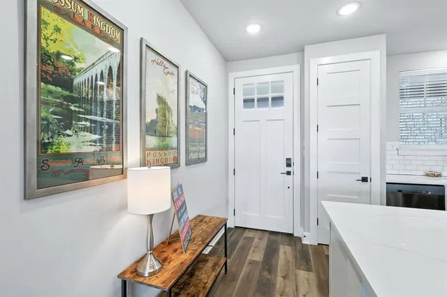 a kitchen with stainless steel appliances a dining table chairs stove and cabinets