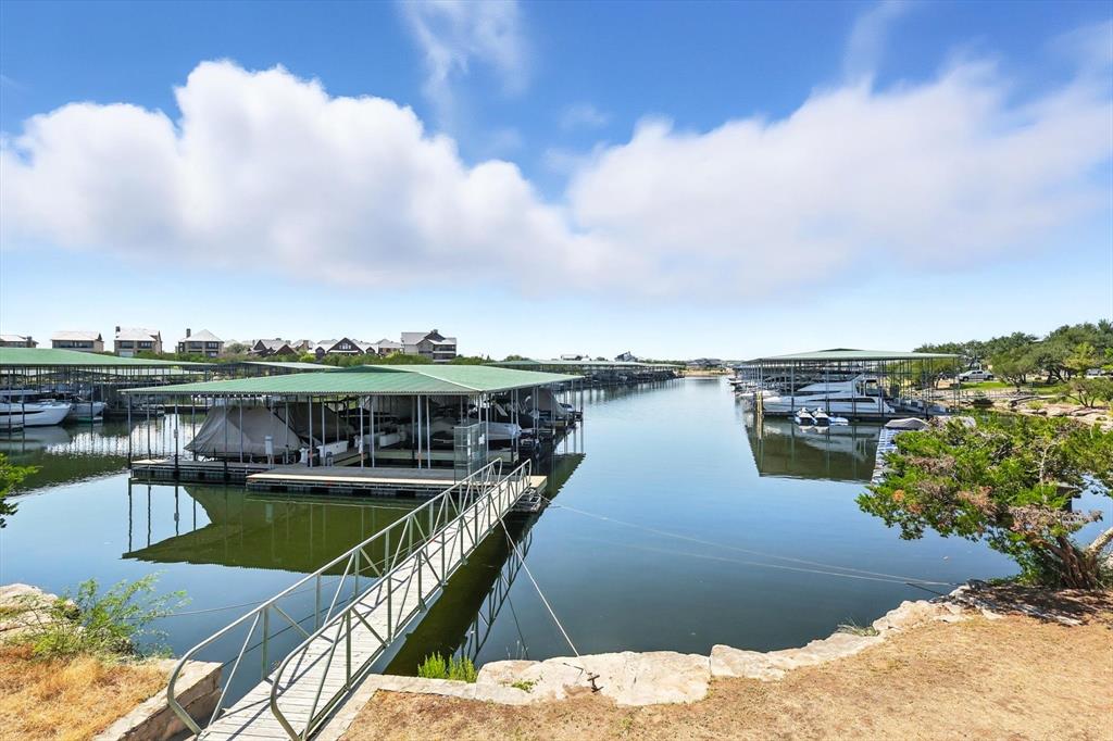 3412 Scenic Point Road, Unit 104 Graford, TX 76449 - Photo 31 of 35 a view of a lake with a city skyline in the background