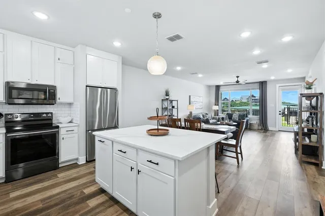 a kitchen with a sink appliances and cabinets