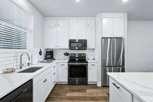 a kitchen with a sink stove and microwave