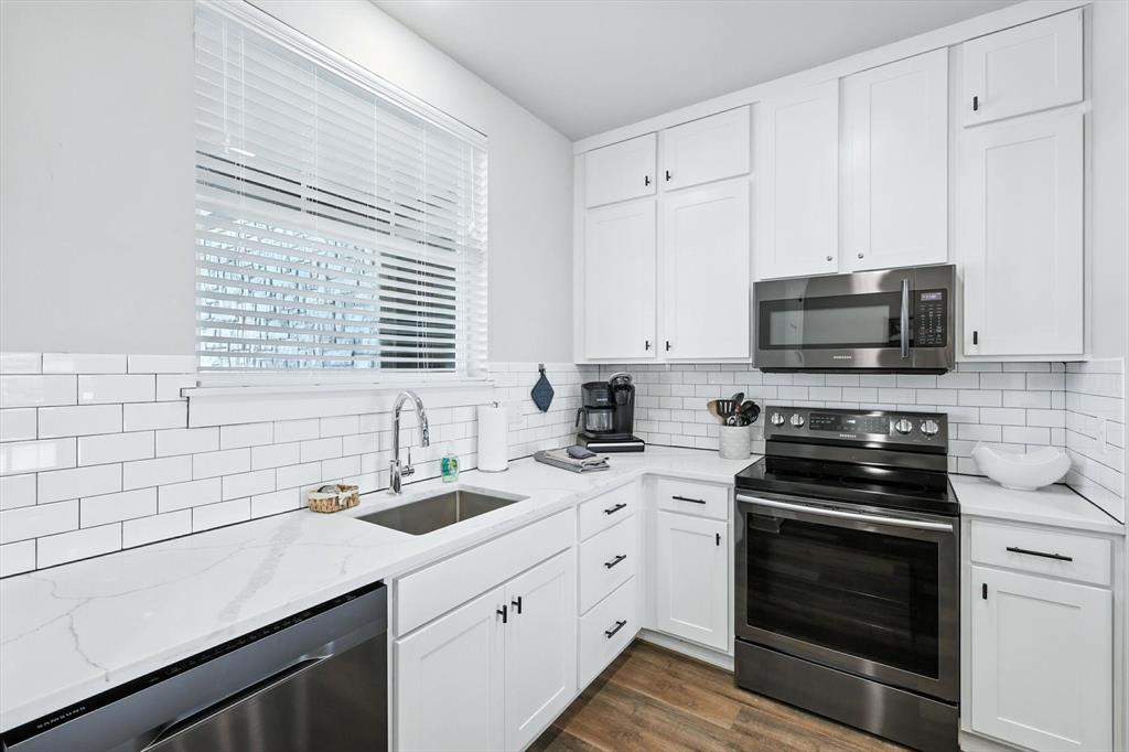 3412 Scenic Point Road, Unit 104 Graford, TX 76449 - Photo 6 of 35 a kitchen with a sink stove and microwave
